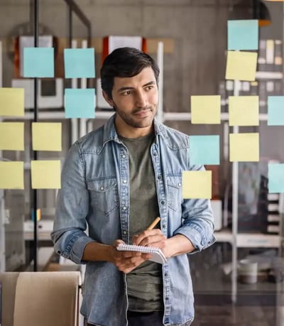 man-looking-at-sticky-notes